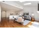 Bright living room featuring skylights, hardwood floors, and a fireplace at 6602 Gaywind Dr, Charlotte, NC 28226