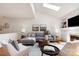 Comfortable living room with skylights, hardwood floors, and neutral decor at 6602 Gaywind Dr, Charlotte, NC 28226