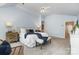 Comfortable main bedroom featuring soft colors, bench seating, and stylish furniture and decor at 6602 Gaywind Dr, Charlotte, NC 28226