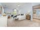 Spacious main bedroom with a sitting area, vaulted ceilings, and large windows with natural light at 6602 Gaywind Dr, Charlotte, NC 28226