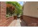 Brick-walled pathway and gated entrance, with manicured landscaping and trees at 6602 Gaywind Dr, Charlotte, NC 28226