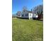 Back exterior showcasing a large yard and a red deck, perfect for outdoor living at 706 13Th Sw St, Hickory, NC 28602