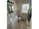 Traditional bathroom with white vanity and tiled floors, offering a clean and functional space at 706 13Th Sw St, Hickory, NC 28602