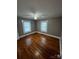 Cozy bedroom featuring hardwood floors, fresh paint, and natural light from the windows at 706 13Th Sw St, Hickory, NC 28602