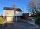 Back exterior view shows a spacious garage, and backyard deck at 706 13Th Sw St, Hickory, NC 28602