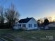 Quaint home with black shutters, a cozy porch and manicured lawn offers curb appeal at 706 13Th Sw St, Hickory, NC 28602