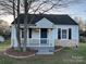 Charming home featuring a cozy front porch, stone accents, and a well-maintained lawn at 706 13Th Sw St, Hickory, NC 28602