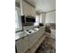 Well-lit kitchen features white cabinets, stainless steel appliances, tile backsplash, and updated countertops at 706 13Th Sw St, Hickory, NC 28602