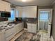 Well-lit kitchen features white cabinets, stainless steel appliances, tile backsplash, and updated countertops at 706 13Th Sw St, Hickory, NC 28602