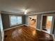 Inviting living room featuring gleaming hardwood floors, neutral paint, and an open doorway to the kitchen at 706 13Th Sw St, Hickory, NC 28602