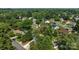 House nestled among lush trees, featuring a well-maintained lawn and established landscaping at 7219 Spring Morning Ln, Charlotte, NC 28227