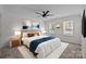 Cozy bedroom with ceiling fan, natural light, neutral decor, and comfortable king-sized bed at 7219 Spring Morning Ln, Charlotte, NC 28227