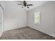 Cozy bedroom featuring soft carpet, ceiling fan, and natural light at 7219 Spring Morning Ln, Charlotte, NC 28227