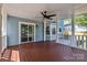 Spacious covered deck with wood flooring, white railings, and a ceiling fan for outdoor comfort at 7219 Spring Morning Ln, Charlotte, NC 28227
