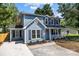 Charming home with dark shutters, manicured landscaping, and a covered front porch at 7219 Spring Morning Ln, Charlotte, NC 28227