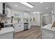 Modern kitchen with white cabinets, stainless steel appliances, granite counters, and bright lighting at 7219 Spring Morning Ln, Charlotte, NC 28227