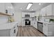 Well-lit kitchen featuring stainless steel appliances, modern white cabinets, and durable countertops at 7219 Spring Morning Ln, Charlotte, NC 28227
