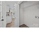 Laundry room in the house with white walls, vinyl floors, and storage rack at 7219 Spring Morning Ln, Charlotte, NC 28227
