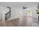 Bright living area with fireplace, ceiling fan, access to the deck, and staircase to the second level at 7219 Spring Morning Ln, Charlotte, NC 28227