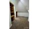 Finished attic space with built in shelving and desk with carpeted floors at 743 S College Ave, Newton, NC 28658