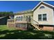 The backyard deck features wood railings and lattice with stairs leading down to a grassy lawn at 743 S College Ave, Newton, NC 28658