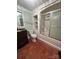Bathroom featuring a tub-shower combo with a glass enclosure, toilet, and vanity with mirror at 743 S College Ave, Newton, NC 28658