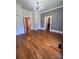 A bedroom featuring a decorative chandelier, hardwood floors and vintage-style wallpaper at 743 S College Ave, Newton, NC 28658