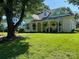Charming yellow two-story home with a front porch, landscaped yard, and mature trees at 743 S College Ave, Newton, NC 28658