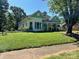 Charming two-story home with a front porch, landscaped yard, and mature trees at 743 S College Ave, Newton, NC 28658