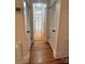 Bright hallway with hardwood floors and a peek into the next room through an open doorway at 743 S College Ave, Newton, NC 28658