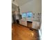 Kitchen with stainless steel appliances, light-colored cabinets, and hardwood flooring at 743 S College Ave, Newton, NC 28658