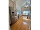 Kitchen with stainless steel refrigerator, wood floors, and light-colored cabinets at 743 S College Ave, Newton, NC 28658