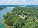 Gorgeous aerial view of Lake Norman homes among lush trees with waterfront access and serene surroundings at 7717 Nautical View Dr, Denver, NC 28037