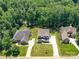 Stunning aerial view of a well-manicured property featuring a lush lawn, mature trees, and pristine landscaping at 7717 Nautical View Dr, Denver, NC 28037