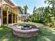 Inviting backyard with a stone fire pit, wooden deck, and lush landscaping, perfect for outdoor entertaining at 7717 Nautical View Dr, Denver, NC 28037
