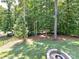 Beautiful backyard with mature trees and a custom-built fire pit, perfect for outdoor gatherings at 7717 Nautical View Dr, Denver, NC 28037
