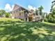 Sprawling backyard showcases the home's brick exterior, a wooden deck, and a lush green lawn at 7717 Nautical View Dr, Denver, NC 28037