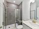 Modern bathroom featuring tiled shower, glass door, gray vanity, and contemporary fixtures at 7717 Nautical View Dr, Denver, NC 28037