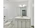Bright bathroom featuring a white vanity, large mirror, and a combination bathtub and shower at 7717 Nautical View Dr, Denver, NC 28037
