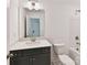 Bathroom with gray vanity, modern lighting, white countertop, and combination shower and tub at 7717 Nautical View Dr, Denver, NC 28037