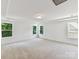 Bright, spacious bedroom with multiple windows, tray ceilings, carpeted floors, and ample natural light at 7717 Nautical View Dr, Denver, NC 28037