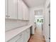 Butlers pantry with white cabinets, a wine fridge, and access to other rooms at 7717 Nautical View Dr, Denver, NC 28037