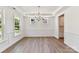 Elegant dining room with classic molding, a chandelier, and beautiful wood flooring at 7717 Nautical View Dr, Denver, NC 28037