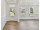 Bright entryway featuring wood floors, white trim, and a view of the outdoors at 7717 Nautical View Dr, Denver, NC 28037