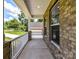 View of the charming covered front porch with white railings and brick accents at 7717 Nautical View Dr, Denver, NC 28037