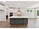 Modern kitchen with a large center island, white cabinets, and stainless steel appliances at 7717 Nautical View Dr, Denver, NC 28037