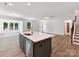 Open kitchen area featuring a center island, stainless steel dishwasher and views to the living area at 7717 Nautical View Dr, Denver, NC 28037