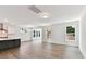 Open concept living room with hardwood floors, white trim, large windows and lots of natural light at 7717 Nautical View Dr, Denver, NC 28037
