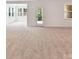 Expansive living room features new carpet and offers seamless access to the backyard through a glass door at 7717 Nautical View Dr, Denver, NC 28037