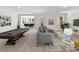 Spacious living room with plush seating, a pool table, and natural light overlooking the dining area at 7717 Nautical View Dr, Denver, NC 28037